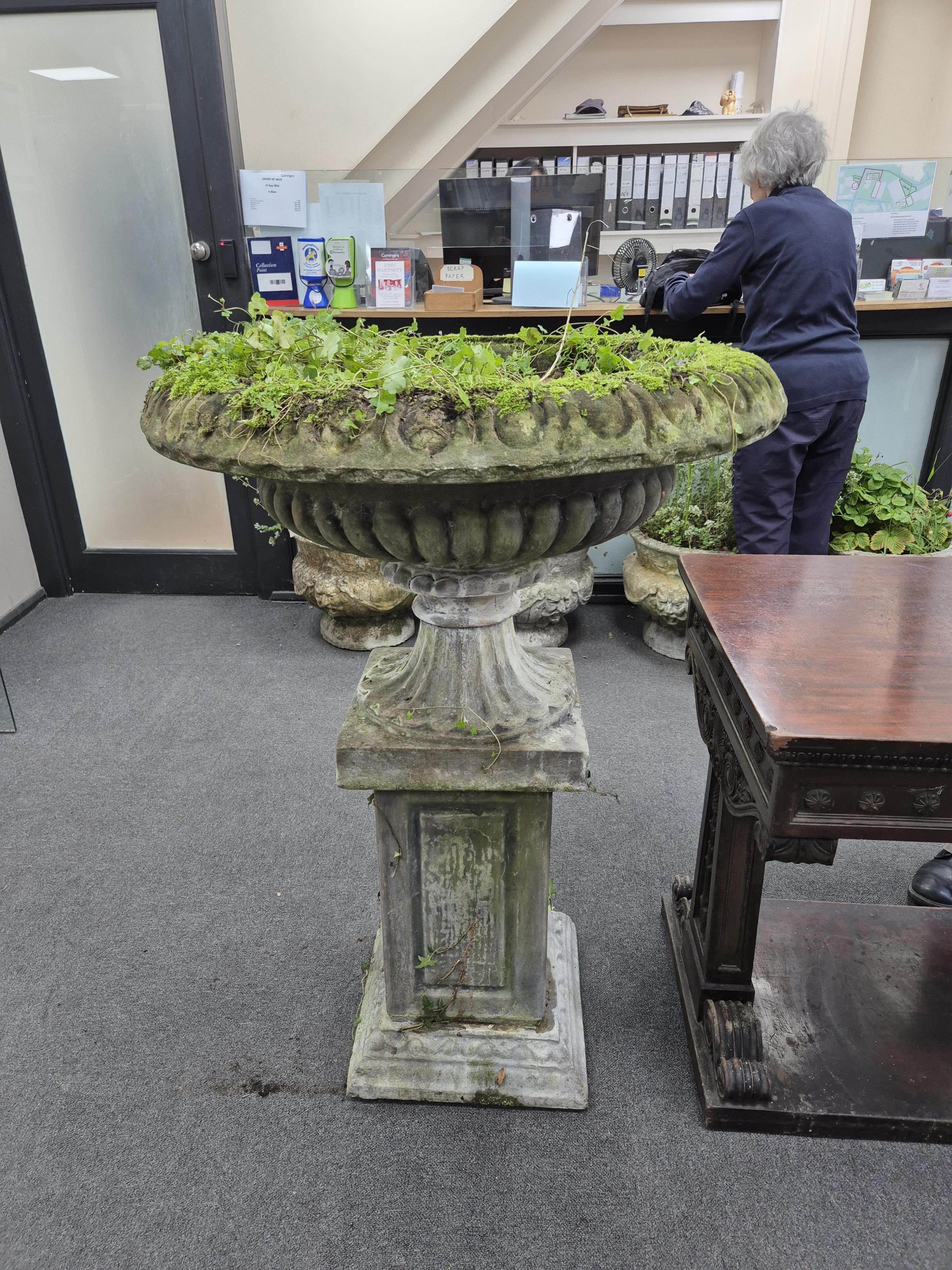 A large reconstituted stone garden vase